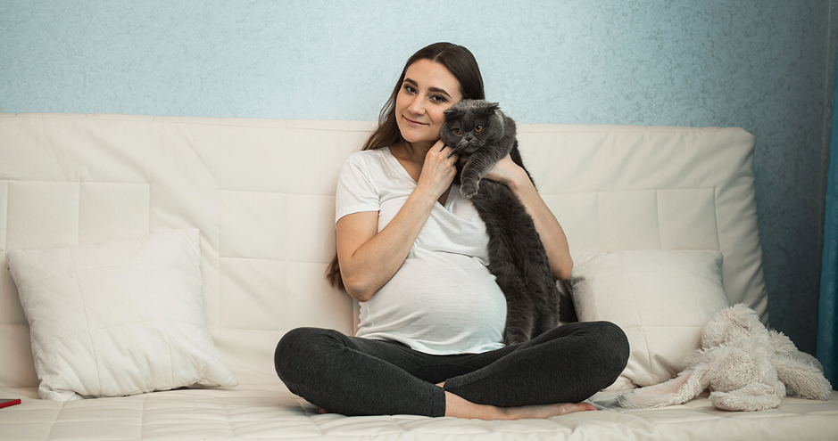 pregnant lady cuddling cat